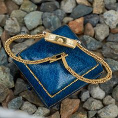 This fantastic vintage Chopard wristwatch (Model No. 5145) features an 18K yellow gold case and bracelet. The case measures 24mm X 14.5mm X 6.3mm. The case is accented with thirty-eight (38) bead set, round brilliant cut diamonds. The back of the case is engraved with the following reference number: SG3810, 171489, 5145. The dial color is champagne and is signed Chopard GENEVE. The movement is a Chopard manual wind, 17 jewel movement. The 18K yellow gold woven style bracelet is finished with a f Classic Yellow Gold Diamond Watch With Jubilee Bracelet, Classic Gold Watch Bands As Gift, Classic Yellow Gold Jubilee Bracelet Watch Accessories, Gold Evening Watch With Jubilee Bracelet, Elegant Yellow Gold Watch Accessories With Jubilee Bracelet, Classic Jubilee Bracelet Watch Accessories As Gift, Elegant Yellow Gold Jubilee Watch Bracelet, Vintage Gold Watch With Jubilee Bracelet, Vintage Yellow Gold Watches With Diamond Hour Markers