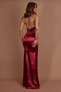 the back of a woman wearing a red gown