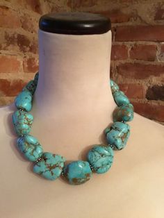 This stunning 18 inch necklace consists of turquoise howlite beads. This necklace is absolutely beautiful!  Please note that there are natural imperfections in the craftsmanship of the pendant as well as natural imperfections in the beads.  The necklace weights approximately 12 ounces and promises to make a statement! Color may vary slightly due to the color calibration of each individual monitor. The pictures simply cannot capture the detail and the beauty of this necklace. Artisan Turquoise Stones Necklace, Gift Turquoise Necklace With Large Beads, Turquoise Necklace With Large Beads, Howlite Gemstone Beads Necklace, Beaded Howlite Turquoise Necklace With Round Beads, Turquoise Gemstone Beads Howlite Jewelry, Turquoise Howlite Gemstone Beads Jewelry, Turquoise Howlite Necklace With Round Gemstone Beads, Elegant Turquoise Necklace With Large Beads