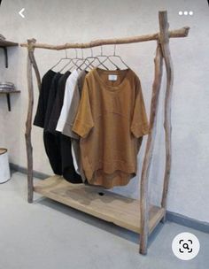 a rack with clothes hanging on it in a room