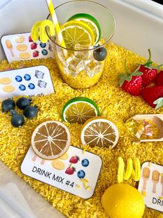 a tray filled with lemons, strawberries, and other food on top of yellow rice