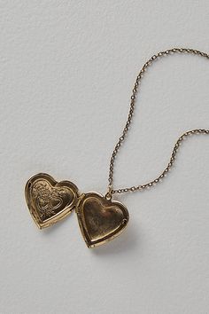 A super sweet gift or an accessory unique to you, this darling monogram necklace features a heart locket pendant with an initial engraving. **Features:** Dainty chain, heart locket pendant, hinge opening mechanism, monogram initial engraving, clasp closure **Why We | Monogram Necklace by Free People in Gold Small Gem Necklace, Good Heart Necklace, Gold Heart Shaped Locket, Cool Unique Jewelry, Meaningful Goodbye Gifts, Initial Necklace H, Heart Locket Necklace Picture, Cute Heart Necklace, A Necklace Initial