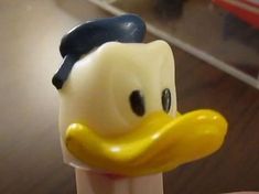 a close up of a toothbrush with a rubber ducky face on it