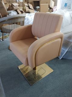 a beige chair sitting on top of a metal stand in a room filled with boxes