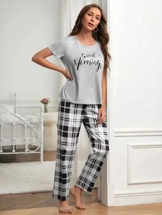 Discover ultimate comfort with our Graphic Tee And Plaid Print Pants Pajama Set. Embrace style effortlessly with plaid and slogan patterns. Designed for relaxation, this pant set offers a loose-fit pajama and short-sleeved tee. Crafted from a fabric with a slight stretch, it ensures unrestricted movement. Enrich your loungewear collection with this blend of style and ease. Features: Pattern Type: Plaid, Slogan Type: Pant Sets Neckline: Round Neck Sleeve Length: Short Sleeve Fit Type: Loose Shee Cotton Plaid Sleepwear For Loungewear, Plaid Cotton Sleepwear For Loungewear, Comfortable Plaid Sleepwear For Loungewear, Plaid Casual Sleepwear For Lounging, Casual Plaid Sleepwear For Lounging, Plaid Relaxed Fit Sleepwear For Loungewear, Plaid Cotton Loungewear Sets, Plaid Sleepwear Pants For Pajama Party, Casual Graphic Print Sleep Bottoms