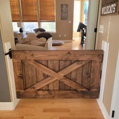 a living room filled with furniture and a wooden gate