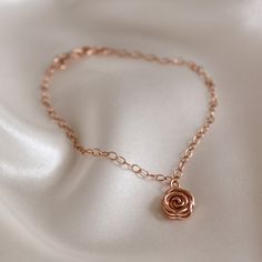 The classic English rose says it all. Whether for a special gift or a special occasion, this pretty and feminine rose gold Rose Bracelet will make a statement that everyone understands. The Rose symbolises love, promise, hope and new beginnings making it a popular choice for wedding jewellery. This dainty bracelet makes a meaningful birthday gift and is perfect for bridesmaid's jewellery. ~ DESIGN ~ This delicate chain bracelet features a rose gold plated or 14k rose gold filled Rose charm set o Personalized Elegant Rose-colored Jewelry, Adjustable Chain Bracelet For Wedding On Valentine's Day, Elegant Personalized Rose Jewelry, Elegant Personalized Rose-colored Jewelry, Elegant Rose Gold Bracelets With Flower Charm, Elegant Rose Gold Bracelet With Flower Charm, Rose Gold Bracelet For Bridesmaid Gift, Elegant Charm Bracelet With Flower Charm As Gift, Elegant Rose Gold Charm Bracelet For Wedding