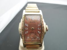 "g341 Vintage Bulova 10K RGP Mechanical Unisex Wrist Watch Pre-owned item. Please see pictures for details. Sold as is, as seen on pictures, no returns on vintage/antique items. We do not alter/polish antique items and try to keep items as original as possible. This is a beautiful Vintage Bulova Mechanical Unisex wrist watch with 17 jewels. 10K RGP , stainless steel bracelet style band. Approx. measurements:  Band length: 3\" Case diameter: 25mm Case Thickness: 7mm Lug: 9mm Watch was checked and Vintage Analog Watch With Rectangular Dial, Vintage Rectangular Chronometer Watch, Vintage Yellow Gold Analog Watch Accessories, Vintage Rectangular Analog Watch Accessories, Vintage Rectangular Watch Accessories, Vintage Watch With Rectangular Dial, Vintage Engraved Rectangular Watches, Vintage Rectangular Engraved Watches, Vintage Gold Watch With Date Display