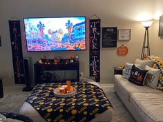 a living room filled with furniture and a flat screen tv mounted to the side of a wall