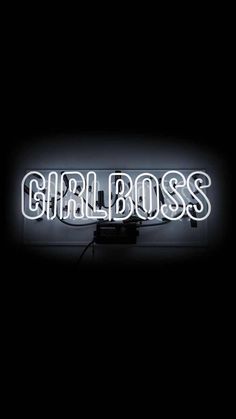 a neon sign that says girl boss in white letters on a black background with the word