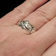 a woman's hand with a silver ring on it