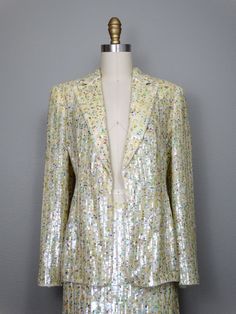 "This is a RARE and AMAZING vintage dress suit! Both pieces are beautifully detailed with sequins all over and accented with beading along the hems. It's in PERFECT condition! Note, measurements are taken with the front brought together, there are no closures on the blazer. Bust - will fit up to 38\" Shoulders - 16\" Sleeves - 24.5\" Length of Jacket - 26\" Skirt Waist - 27\" Hips - 38\" Length of Skirt - 23\" Tag Size - 4 This item comes from a pet-free and smoke-free home. If you would like mo Glamorous Embellished Sequin Fabric For Spring, Glamorous Spring Embellished Sequin Fabric, Spring Contrast Sequin Fabric For Cocktail, Fitted Sequin Fabric With Contrast Sequins For Spring, Fitted Contrast Sequin Fabric For Spring, Fitted Sequin Fabric For Spring, Long Sleeve Sequin Dress For Spring Formal, Glamorous Fitted Sequin Fabric For Spring, Fitted Sequin Fabric For Spring Party