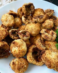 some fried food on a white plate with broccoli