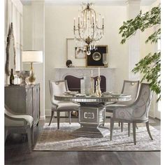 a dining room table with chairs and a chandelier