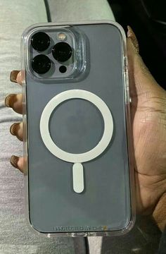 a person holding an iphone case with a magnifying glass on the back cover