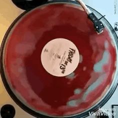 a close up of a red and black record player