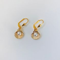 Gold Plated seashell and faux pearl earrings. These earrings dangle from a gold plated lever back setting. Very pretty earrings! Elegant Gold Dangle Shell Earrings, Elegant Gold Dangle Shell, Elegant Gold Shell With Lobster Clasp, Gold Dangle Shell Earrings With Pearl Drop, Gold Shell Earrings With Pearl Charm, Gold Pearl Drop Earrings In Shell Shape, Celtic Circle, Celtic Knot Earrings, Marble Earrings