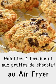 some cookies are cooling on a rack with chocolate chips and oatmeal toppings