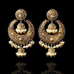 A fun pair with classic deign that never goes out-of-style! Gorgeous pair of earrings that is a perfect pick to pull-off any traditional or ethnic look. With its beautiful metal carving, embossed details and timeless jhumki design with an addition to pearl moti, this pair is all you need for the upcoming events. Kajal Earrings are available in two sizes. Big earrings are about 4.5" long and small earrings are about 3" long. Gold-plated on high-quality brass as base metal. Delivery time frame is Traditional Earrings With Intricate Design, Elegant Oxidized Earrings For Ceremonial Occasion, Elegant Ceremonial Earrings With Oxidized Finish, Ornate Chandbali Brass Jewelry, Ornate Gold Chandbali Earrings, Ceremonial Chandbali Metal Earrings, Ornate Metal Chandbali Jewelry, Temple Jewelry Earrings With Intricate Design For Festivals, Ornate Jhumkas For Pierced Ears