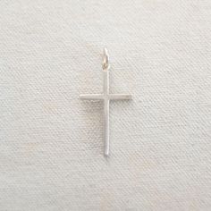 One of several different cross options. This is our thinner and smaller cross and can be worn independently or combined with our charm necklaces. A great way to keep your faith close to you! Available in Gold Fill or Sterling Silver Dimensions: 1 1/4" long and 2/3" wide Everyday Minimalist Cross Pendant Necklace, Minimalist Everyday Cross Necklace, Minimalist Daily Wear Cross Pendant Necklace, Everyday Cross Pendant Charm Necklace, Everyday Silver Cross Pendant Necklace, White Spiritual Cross Pendant Jewelry, Hypoallergenic Cross Jewelry For Everyday, Silver Crucifix Cross Necklace For Everyday, Simple Everyday Cross Pendant Necklace