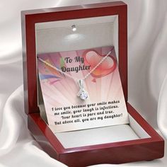 14k White Gold Over Stainless Steel 7mm round cut Cubic Zirconia ﻿Stylish gift box and message card Show your daughter how much you love her with this beautiful Alluring ribbon pendant necklace. This beautiful pendant is truly a one-of-a-kind gift for any daughter. The ribbon design is embellished with dainty cubic zirconia, which is followed by a beautiful 7mm round cut Cubic Zirconia. Crafted with 14k White Gold over Stainless Steel, this necklace dresses up any occasion. The adjustable oblate Necklace Dress, Ribbon Design, Luxury Boxes, Stylish Gifts, Message Card, My Daughter, Make Me Smile, To My Daughter, Round Cut