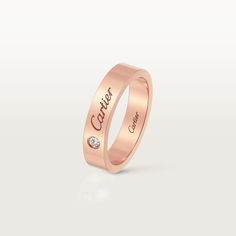 a rose gold wedding ring with the name canon engraved on it's outside side