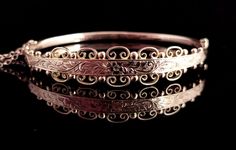 "A superb antique Edwardian 9ct gold floral engraved bangle.  A very pretty design with a slim plain polished back.  The front is wider with an elaborate floral engraving bordered by gold beading and scroll work.  A truly beautiful and intricate design, it is yellow gold with rosey hues depending on how the light hits.  The bangle is fully hallmarked for 9ct gold Birmingham 1909. The back is hollow and it has a push clasp and attached gold safety chain.  Approx measurements: 7.45\" outer circumference  2.25\" inner width  1.90\" inner length  Front 12.2mm width  Back 3.2mm width  Weighs 6.22 grams Condition:  Good used condition overall, some light surface wear commensurate with age, one small ding to the reverse, see photos.  Any questions or queries please contact us. FREE WORLDWIDE SHIP Victorian Gold Wedding Bracelet Stamped 14k, Victorian Gold Bracelet For Wedding, Antique 14k Gold Bangle, Ornate Engraved Bangle For Wedding, Ornate Engraved Wedding Bangle, Ornate Engraved Bangle For Formal Occasions, Gold Victorian Bangle With Intricate Design, Victorian Gold Bracelet With Intricate Design For Wedding, Antique Engraved Gold Bracelet For Wedding