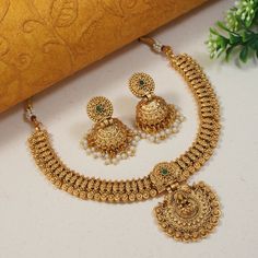 This Beautiful flexible Indian Bollywood necklace jewellery set with earrings is perfect for special occasions such as weddings, formal events, or cultural celebrations. It is certain to add a touch of glamour and sophistication to any outfit, and is guaranteed to make you feel like royalty. If you're looking for a show-stopping piece of jewelry that will make you stand out from the crowd, this set is an excellent choice. Add this charm of Indian Jewelry to your wardrobe and see the heads turn. A perfect enchanting piece of jewelry that is both dramatic and elegant is here to assist you on your special days. Necklace Closure - Adjustable Dori Earrings Closure - Push Back Highest quality and craftsmanship CARE TIP :- 1. Keep away from moisture and perfume. 2. Store in cotton or zip lock bag Short Necklace Gold Indian Bridal, Gold Jhumkas For Marriage And Festive Occasions, Festive Gold Jhumkas For Marriage, Gold Chandbali Jhumkas For Marriage, Gold Bollywood Jhumkas For Marriage, Bollywood Style Gold Jhumkas For Marriage, Traditional Gold Tikka For Marriage, Traditional Jewelry Set For Marriage On Diwali, Gold Festive Sets For Marriage