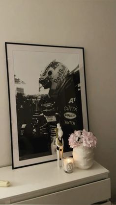 a framed photograph sitting on top of a white dresser