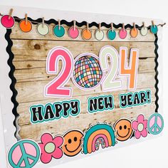 a wooden sign that says happy new year with peace signs and symbols around the frame