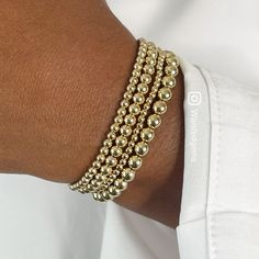 "14k Gold Filled Beaded Bracelet is handcrafted with 14K yellow gold filled or sterling silver smooth round 2.5mm, 3mm, 4mm & 5mm beads strung on a durable elastic cord a crimp cover bead is used to cover the elastic knot for a seamless finish. This one bead will have a seam. These are beautiful, elegant, and modern pieces. They are great for stacking or wearing alone. These bracelets are sold Individually and come in a cute brand box ready for gift giving. If a full set (4) Four Bracelets a Edgy Bracelets, Egyptian Inspired Jewelry, Custom Charm Bracelet, Gold Beaded Bracelet, Urban Jewelry, Luxury Bracelet, Jewelry Bracelets Gold, Gold Bead Bracelets, Unisex Gift