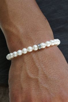 Featuring premium Freshwater Pearls, sterling silver hardware and a single Maya David silver bead, this bracelet combines classic elegance with a modern edge. A must-have in any man's jewelry collection. Sterling Silver Freshwater Pearls 7mm Thickness Push Clasp Handcrafted in LA Pair with our Men's Pearl Necklace Determining your bracelet size: Encircle your wrist with a flexible tape measure and record the measurement. Because of the larger pearl size, add 3/4 to 1 inch to your wrist measureme Classic Adjustable Beaded Bracelets For Anniversary, Classic Stackable Sterling Silver Bracelet For Gift, Classic Stackable Sterling Silver Bracelet Gift, Classic Single Strand Pearl Bracelet For Everyday, Classic Stackable Sterling Silver Bracelet, Timeless White Sterling Silver Bracelet For Anniversary, Classic Everyday Single Strand Pearl Bracelet, Classic Silver Beads Bracelet As A Gift, Classic Silver Beads Bracelet Gift