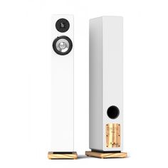 a pair of white speakers sitting next to each other on top of a wooden stand