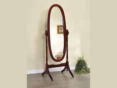 a large mirror sitting on top of a wooden stand