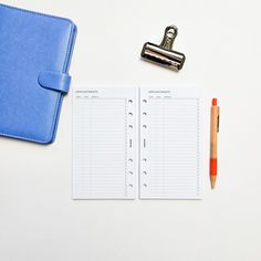 a notepad, pen and clipboard on a desk