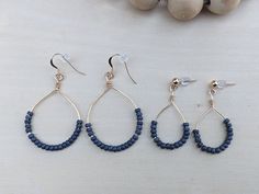 These handmade dangle hoops are made with gunmetal gray seed beads. Against the gold it's a beautiful combination and will go with anything. These beauties are perfect for a special night out or for feeling beautiful on your everyday errands. The perfect gift for yourself or someone you love. Choose between two sizes. Small have a drop of roughly 1.5 inches Large have a drop of roughly 2 inches  Please be aware that these are handmade so no two pairs are exactly alike, slight variances are to be Seed Bead Hoop Earrings, Bead Hoop Earrings, Handmade Hoop Earrings, Hippie Earrings, Handmade Jewelry Gift, Gunmetal Grey, Beaded Hoop Earrings, Beaded Hoops, Gift For Girlfriend