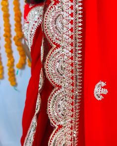 Beautiful Red Georgette Chiffon saree with hand Sabyasachi designer gotta patti and Zardozi flowers in the body. comes with 2 blouses - one sticthed - size 38-42 , back closure , padded, half sleeves. And a blouse fabric. This saree is ready to wear with falls,pico and beautiful handwoven tassels , and unstitched blouse fabric is included. Note: Colors that show up on your screen may vary slightly from the actual product due to variations in settings. Also, the actual product may appear to be different hues depending on the ambience lighting. Note: There may be very slight inconsistencies such as in the weave/motiff work, there being characteristics are not considered defects. Any jewelry shown is for general purpose only and is not included with the saree. Red Georgette Sharara With Cutdana, Red Blouse With Dupatta For Eid, Georgette Pre-draped Saree With Mirror Work For Puja, Red Traditional Wear With Mirror Work, Traditional Drape Georgette Blouse With Zari Work, Festive Transitional Saree With Mirror Work, Traditional Drape Blouse In Georgette With Cutdana, Traditional Drape Georgette Blouse With Cutdana, Red Georgette Choli With Cutdana