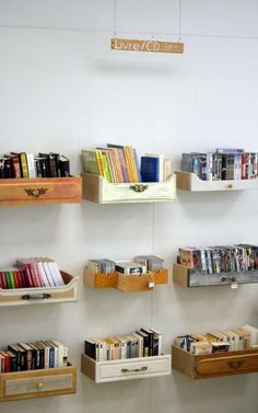 the shelves are filled with books and other items for display on the wall behind them