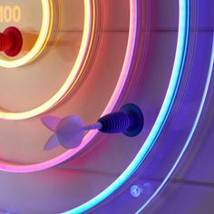 a close up of a clock with neon lights