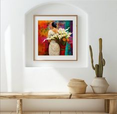 a painting hanging on the wall above a wooden bench with two vases filled with flowers