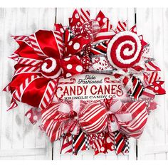 a red and white wreath with candy canes on it