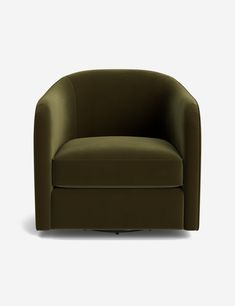 a dark green chair sitting on top of a white floor