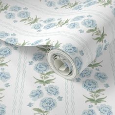 a close up view of a blue and green floral pattern on a white wallpaper