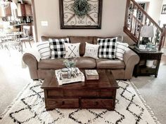 a living room filled with furniture and pillows on top of a white carpeted floor