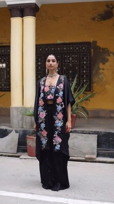 Planning for an upcoming wedding cocktail? Look no further! This exquisite ensemble is designed to make you shine. Introducing the Black Floral Embroidered Patchwork Cape Set, a stunning choice for those seeking elegance in cocktail and party ethnic wear for women. This fashionable cape set showcases beautiful floral embroidery designs that elevate its charm and sophistication. Floral Embroidery Designs, Cocktail Look, Sheer Cape, Cape Set, Cape Fashion, Ethnic Wear For Women, Nehru Jackets, Wedding Cocktail, Wedding Cocktails