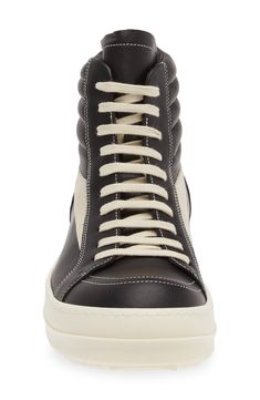 Crafted from full-grain leather and suede, this high-top sneaker is quintessentially Rick Owens with its blunted toe, dramatic lacing and shark-tooth sole. Drawing inspiration from vintage silhouettes and color schemes, this boldly topstitched shoe blends modern comfort with a timeless aesthetic. Lace-up style Leather upper and lining/rubber sole Made in Italy Designer Shoes Black Calf Leather High-top Sneakers For Streetwear, Calf Leather Lace-up High-top Sneakers, Lace-up High-top Sneakers In Calf Leather For Streetwear, Lace-up High-top Calf Leather Sneakers For Streetwear, Lace-up High-top Calf Leather Sneakers, Sporty High-top Sneakers With Vulcanized Sole In Calf Leather, Calf Leather High-top Sneakers With Abzorb Midsole For Streetwear, Calf Leather High-top Sneakers With White Sole For Streetwear, Modern Calf Leather High-top Sneakers For Streetwear