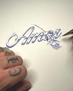 someone is drawing the word almost on paper with their fingernails and holding a pen