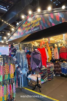 the inside of a clothing store with clothes on display