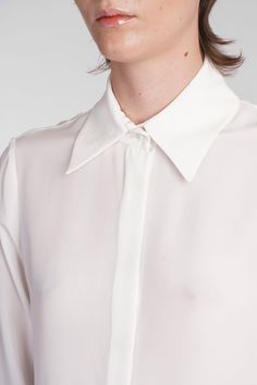 Keltie Shirt in beige silk, collar, long sleeves, hidden closure with buttons, buttons on the wrists, straight hem, semisheer, 100% silk, Made in Lithuania, Model is 180 cm and wears 36 Elegant Silk Tops With Concealed Placket, Elegant Silk Shirt With Concealed Placket, White Blouse With Concealed Placket For Office, Silk Shirt With Hidden Button Closure And Long Sleeves, Silk Shirt With Hidden Button Closure, Designer Silk Collared Shirt, Elegant Silk Shirt With Hidden Button Closure, Luxury Silk Blouse With Concealed Placket, Elegant White Blouse With Concealed Placket