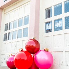 red and pink ornaments in front of a building